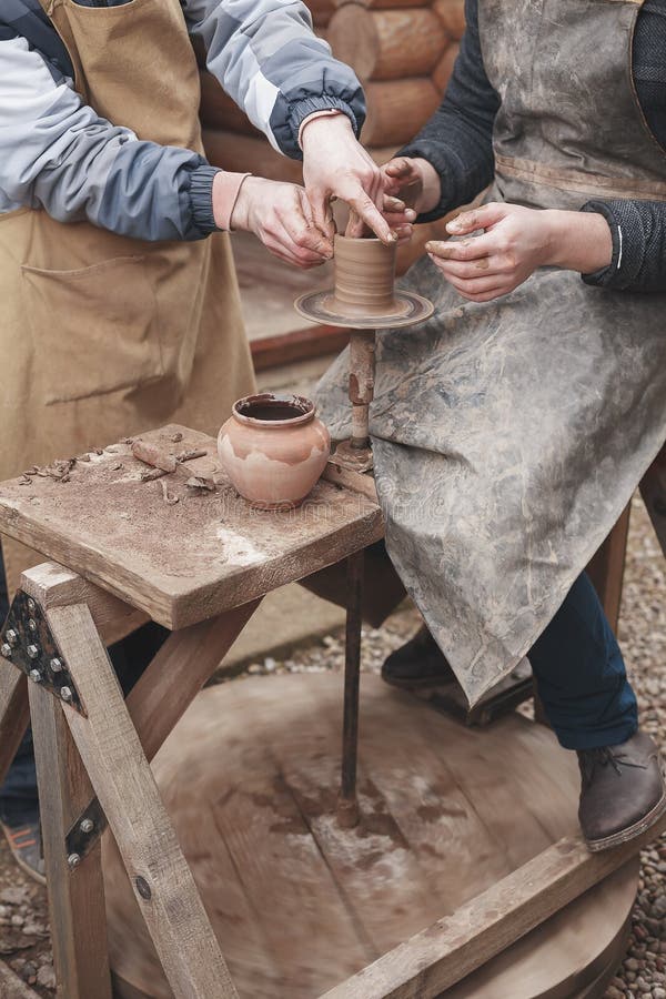 The Hands of Potter Help Make Pitcher on Pottery Wheel Stock Image