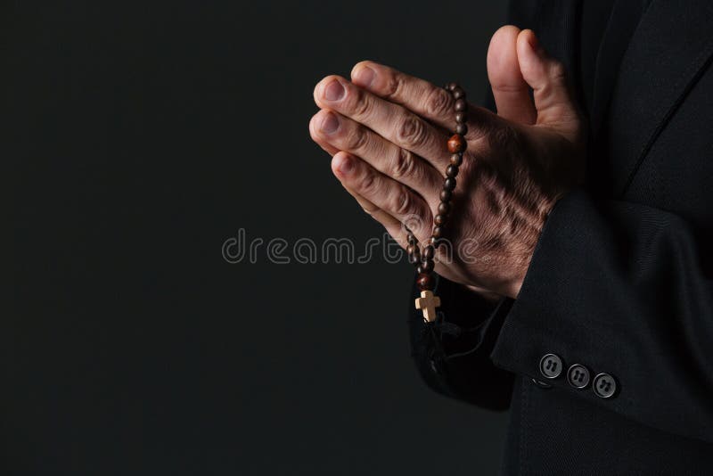 Hands of priest holding rosary and praying royalty free stock photo Hands of priest holding rosary and praying royalty free stock photo