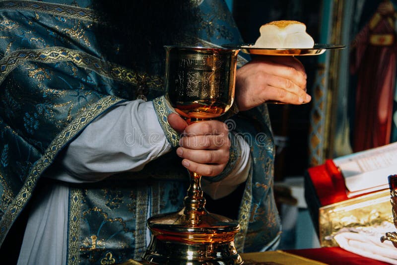 Hands of priest and orthodox prosphora