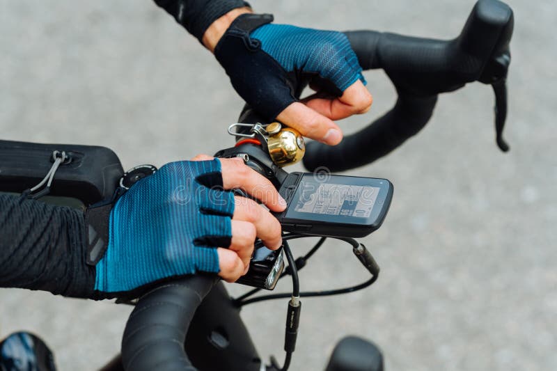 Hands of a professional cyclist on the handlebars with a bicycle computer, close photo royalty free stock images
