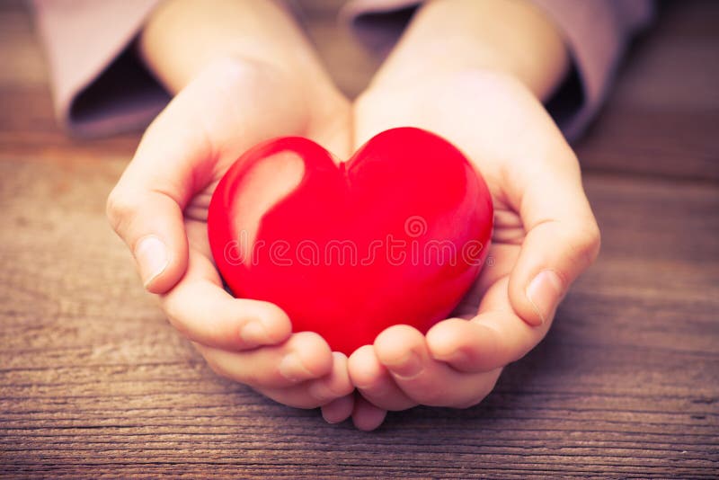 Hands holding a heart as safety concept. Hands holding a heart as safety concept