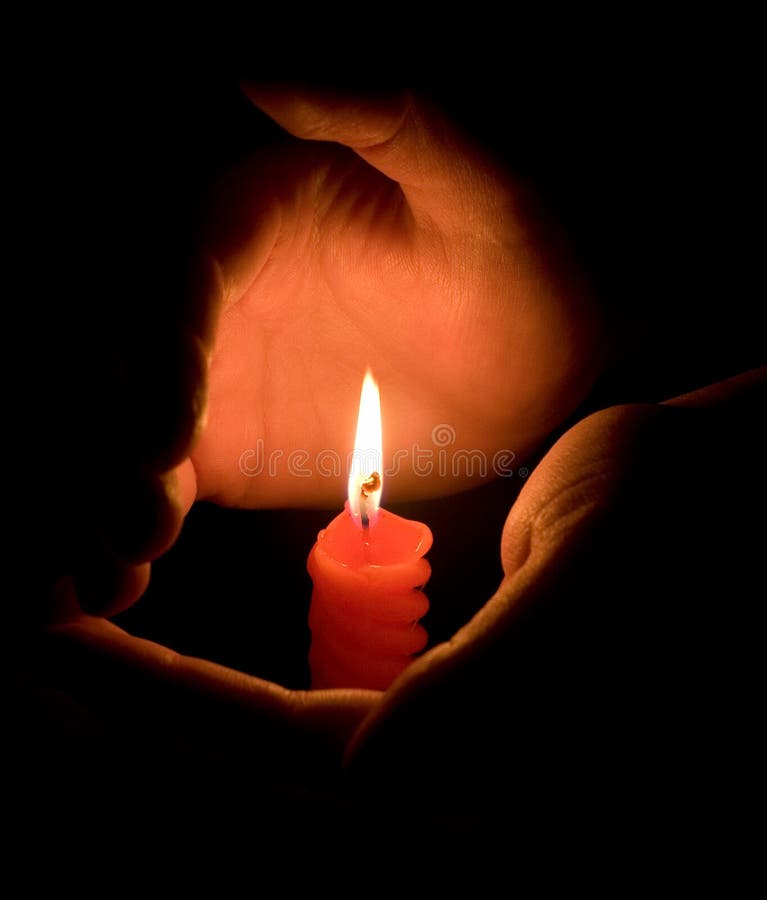 Hands protecting a candlelight