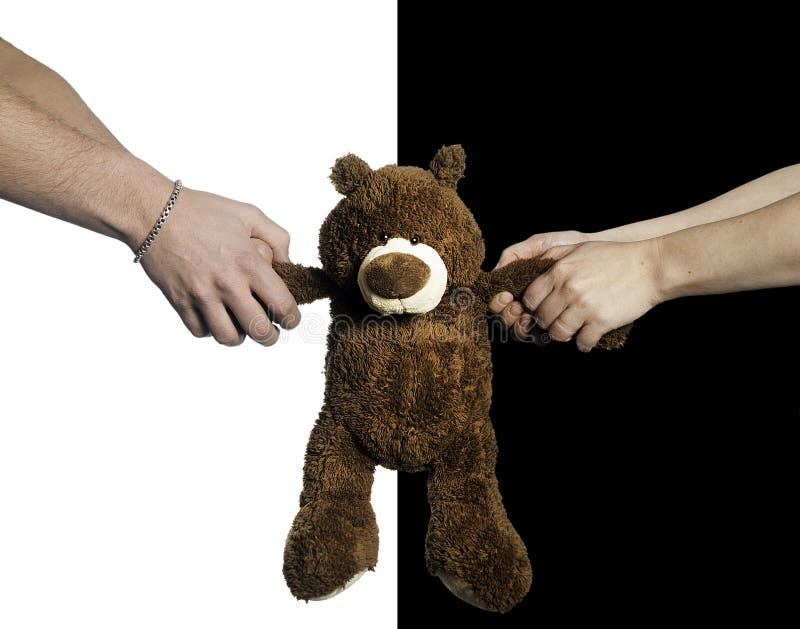 Hands pulling a teddy bear against black and white background.2013-1-11