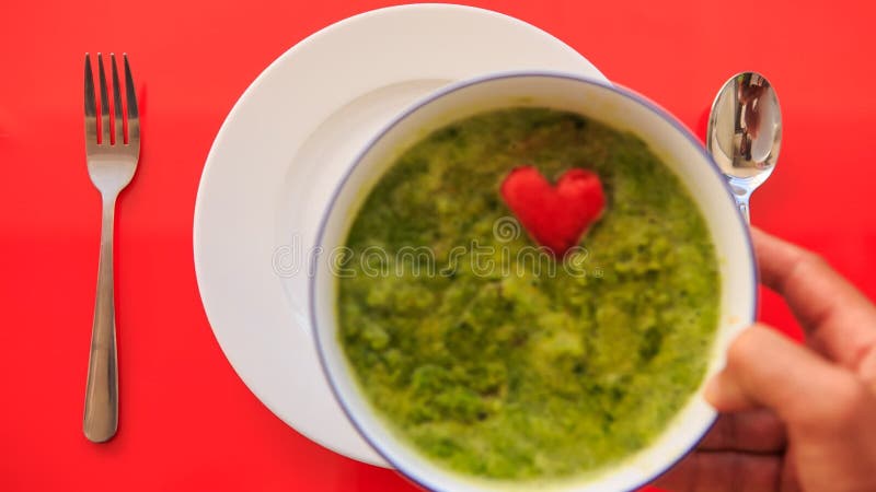 Hands Put Bowl of Soup to Plate Fork Spoon Nearby on Red Table