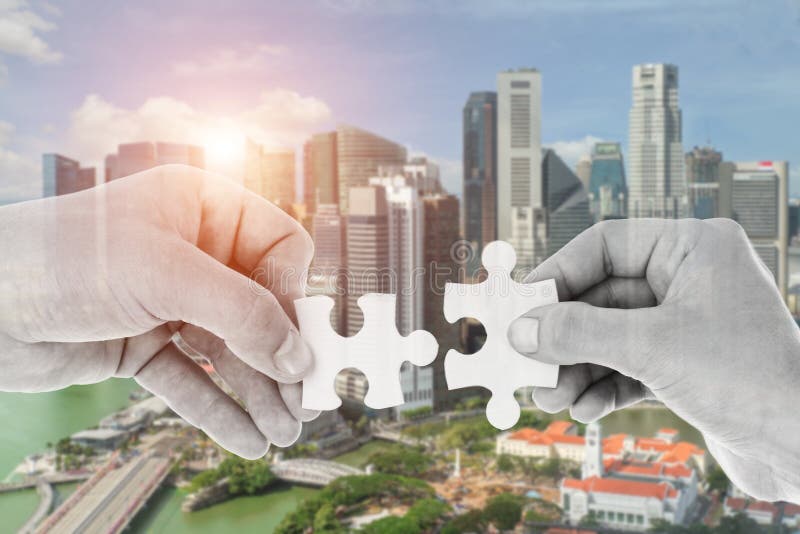 Hands putting partnership puzzle pieces together stock photos