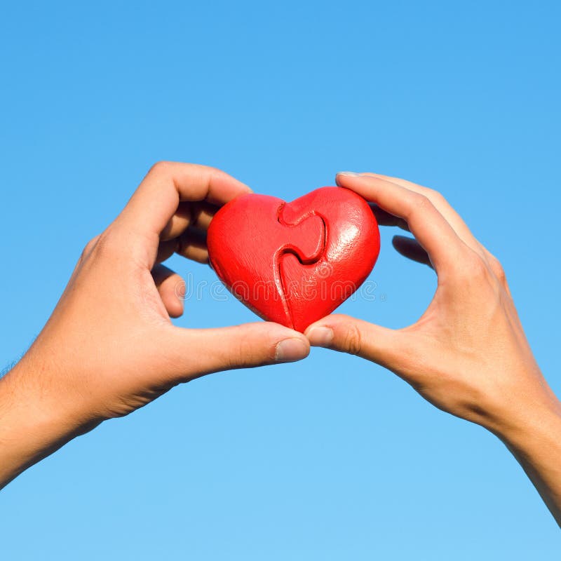 Hands with puzzle heart royalty free stock images