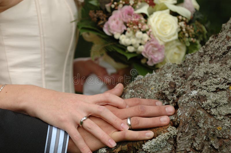 Hands, rings and bouquet