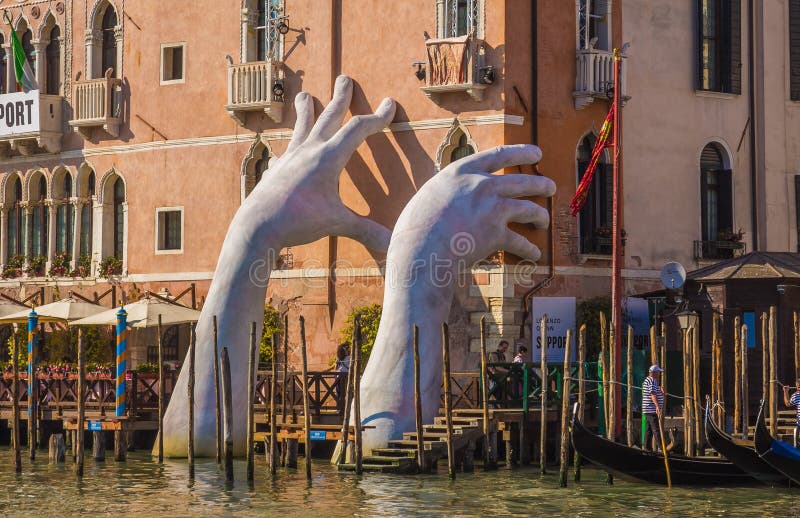 Hands rise from the water in Venice to highlight climate change