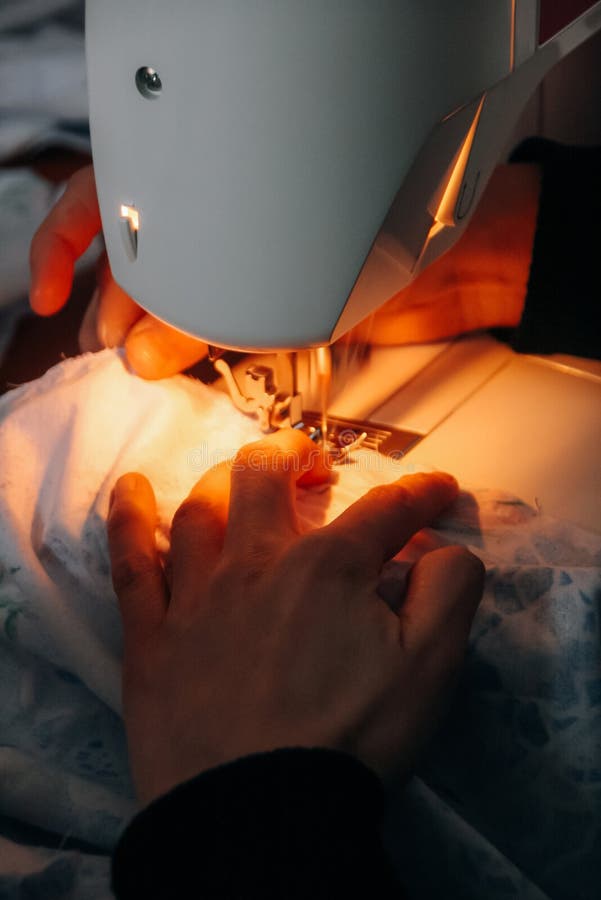 Hands sewing on a machine stock image. Image of material 112742809