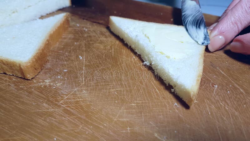 Hands smear butter on bread appetizer closeup smear margarine