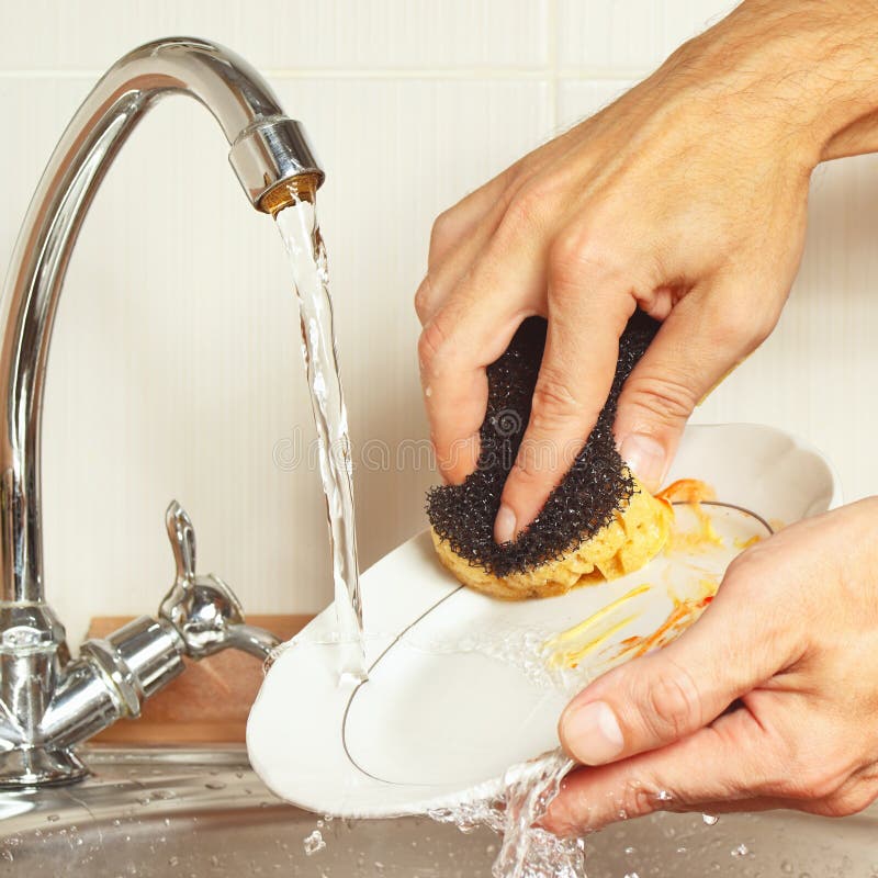 Hands with Sponge Wash the Dirty Dishes Under Running Water in Kitchen