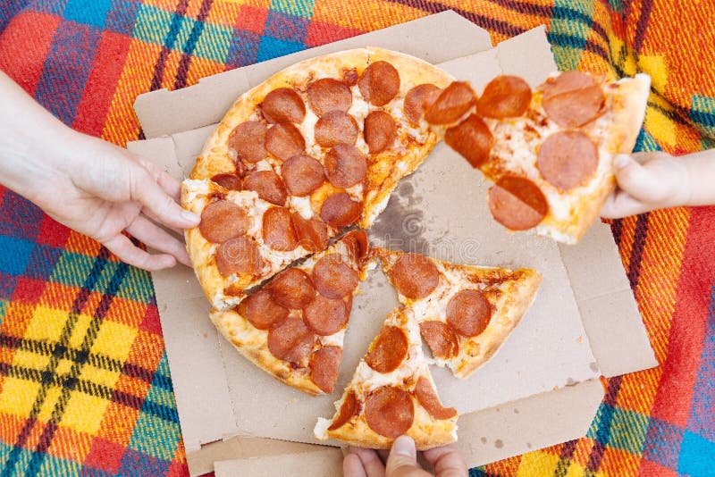Hands Take Slices Of Pepperoni Pizza Food Delivery Picnic Stock Image