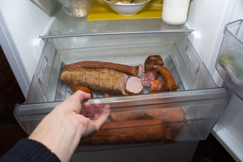 Hands to the sausage from the fridge