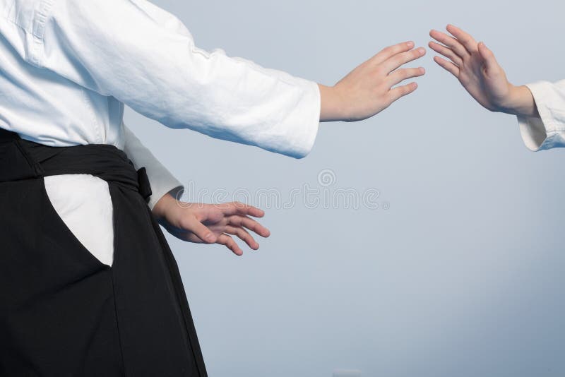 Hands of Two Girls Standing in Stance on Martial Arts Training Stock
