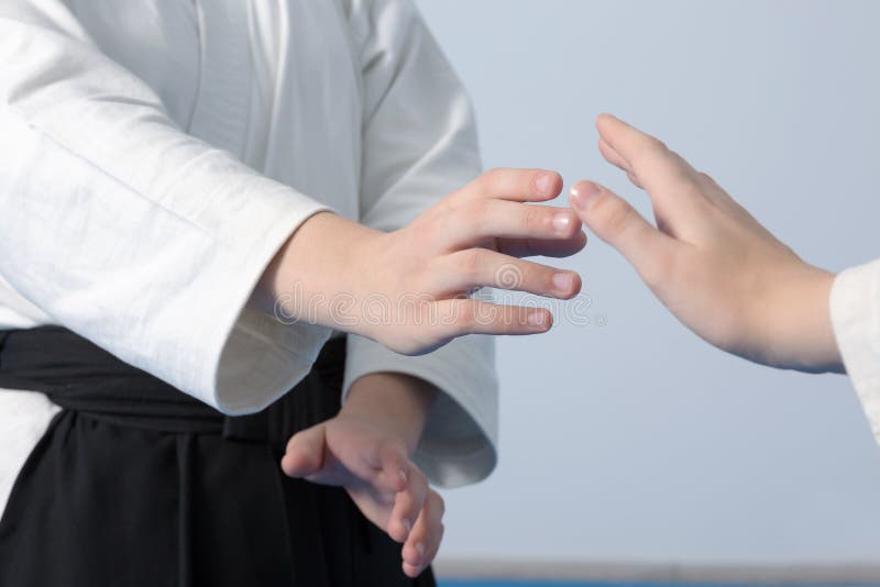 Hands of Two Girls Standing in Stance on Martial Arts Training Stock