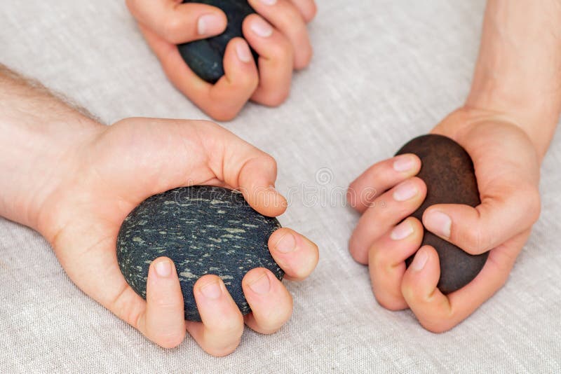 Hands of Men Holding Spa Stones Top View. Stock Photo Image of closeup, black 187378880
