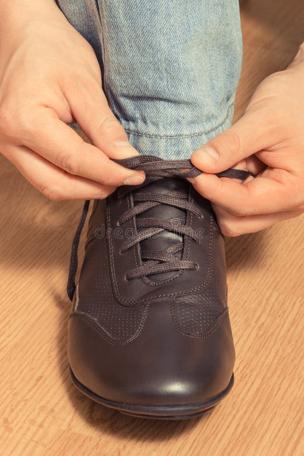 Hands Tying Shoelaces of Brown Leather Shoe Stock Photo Image of