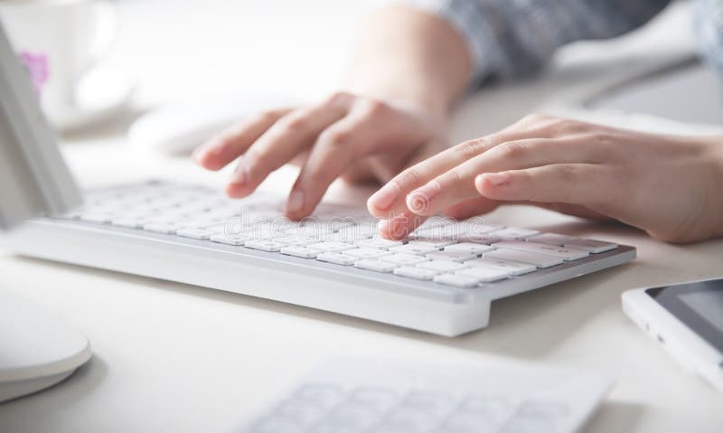 Hands typing on computer keyboard in office desk royalty free stock image