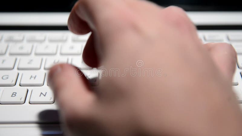 Hands typing text on a laptop keyboard closeup