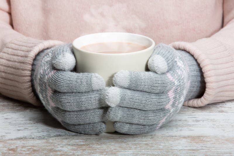 Hands in Warm Gloves Hold a Cup with a Hot Cocoa Drink, Tea or ...
