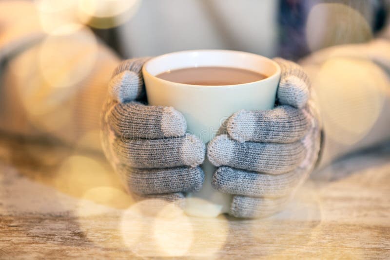 Hands in Warm Gloves Hold a Cup with a Hot Cocoa Drink, Tea or ...