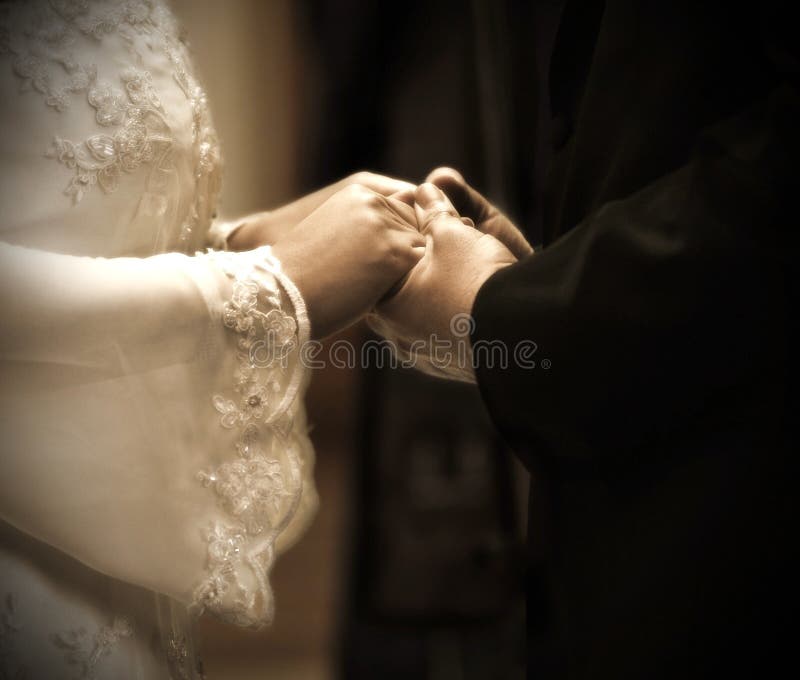 Hands in wedding ceremony