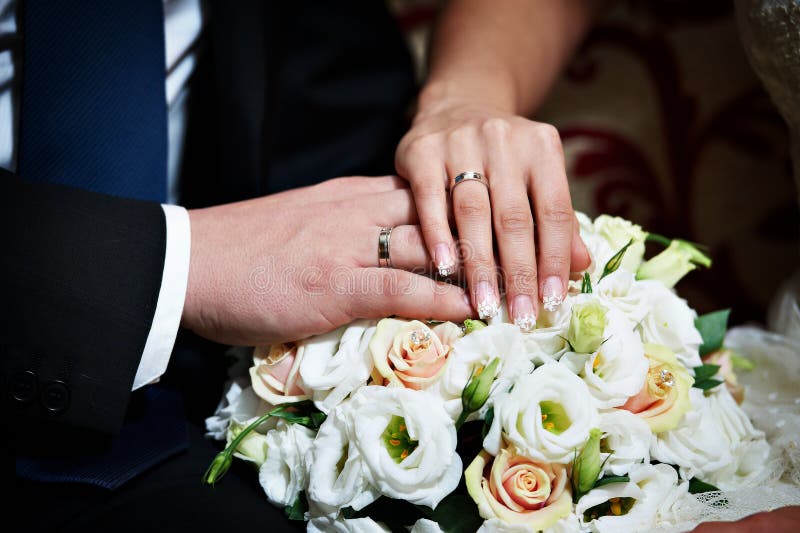 Hands with wedding gold rings happy newlyweds