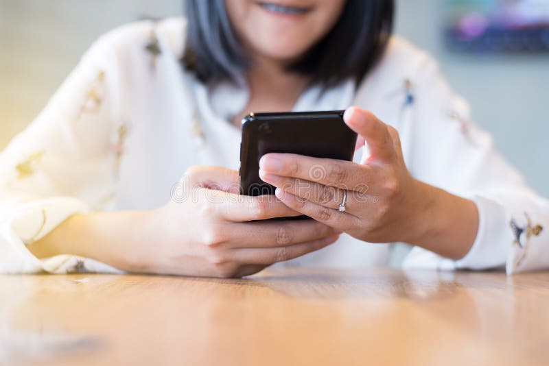 Hand woman using mobile phone,social media,connection wifi relaxed girl checking cell phone at restaurant royalty free stock photo Hand woman using mobile phone,social media,connection wifi relaxed girl checking cell phone at restaurant royalty free stock photo