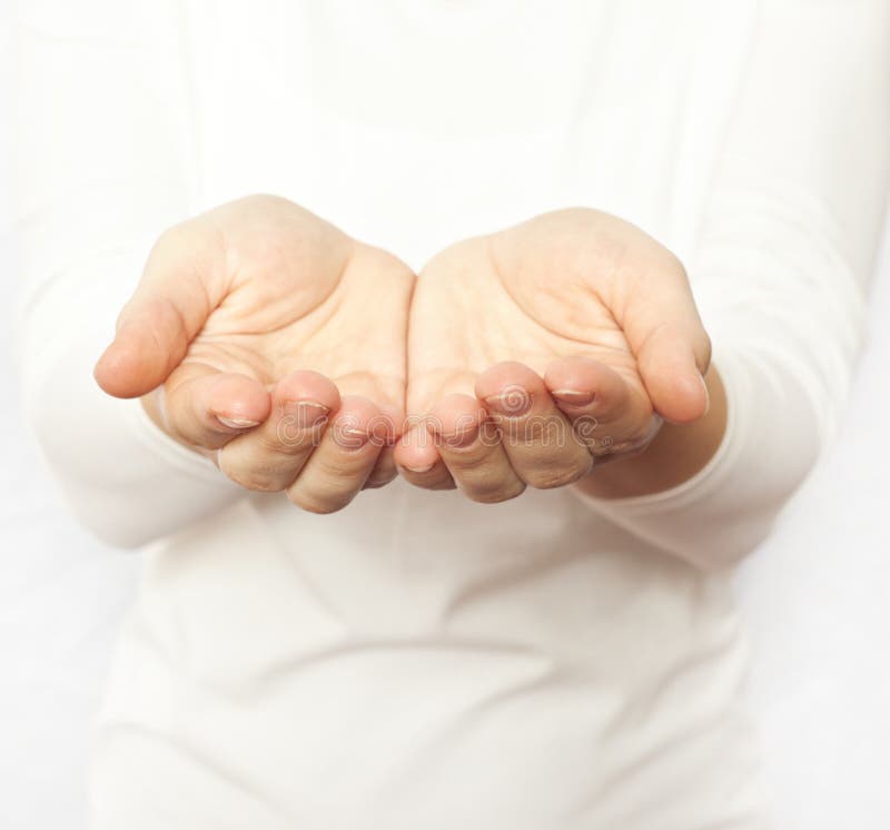 The woman in white holding open hands