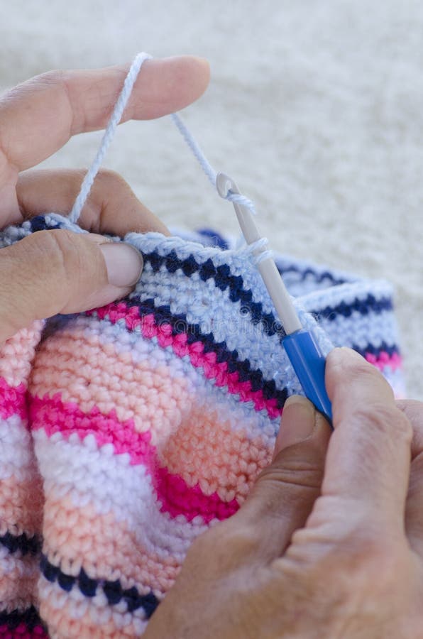 Crochet Needle and Handmade Lace Sitting on Top of Hundred Dollar Bills