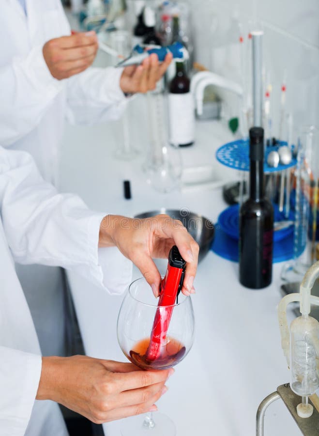 Hands Working in Chemical Laboratory Checking Wine Qualities Stock