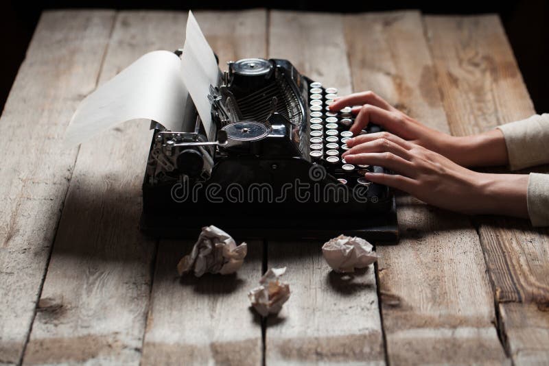 Hands writing on old typewriter over wooden table royalty free stock photos Hands writing on old typewriter over wooden table royalty free stock photos