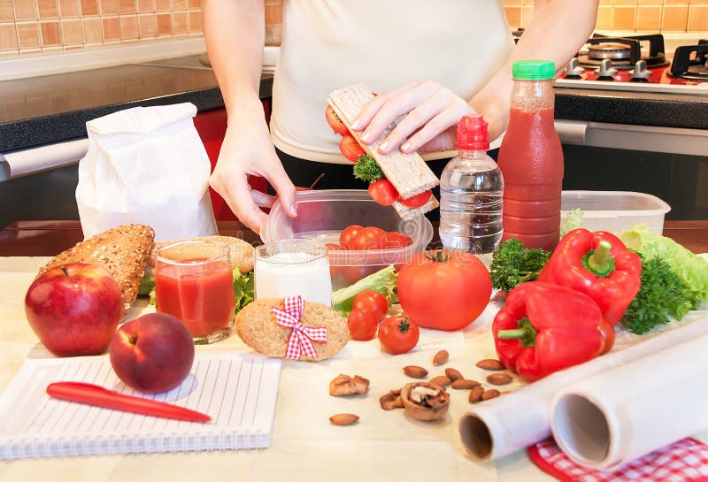Hands of a young woman preparing school lunch box. stock image Hands of a young woman preparing school lunch box. stock image