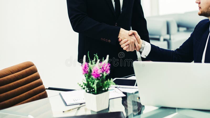 Handschlag zwischen Kollegen am Arbeitsplatz in einem Büro stockfotografie