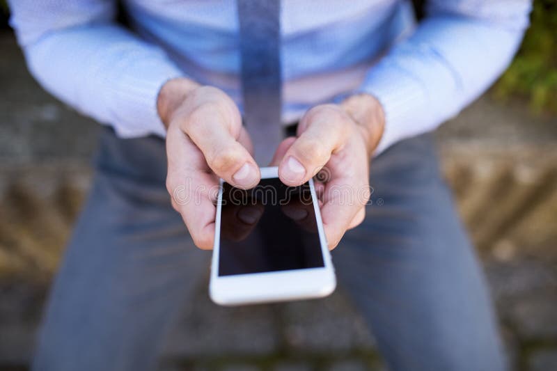 Close up of hands holding smartphone. Businessman scrolling on smartphone. Close up of hands holding smartphone. Businessman scrolling on smartphone