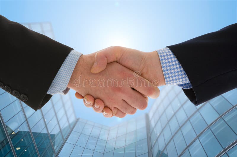 Handshake. With modern skyscrapers as background Handshake. With modern skyscrapers as background