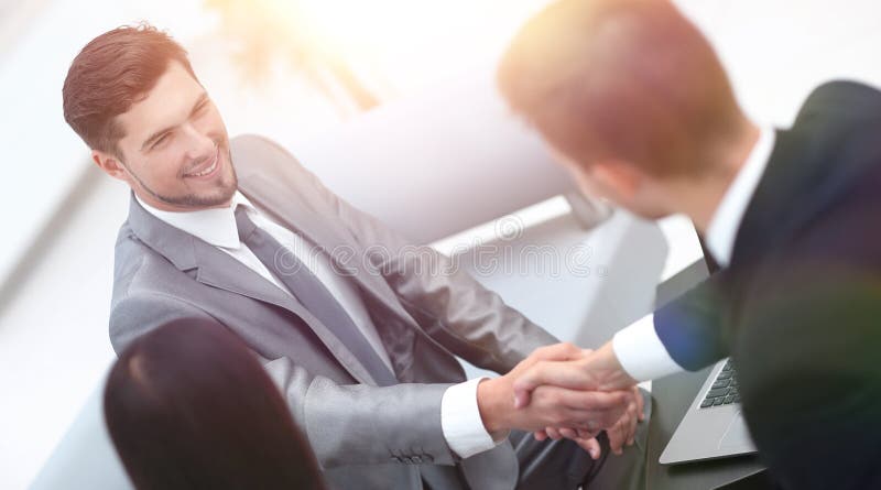 Handshake business partners in the lobby of the office. photo with copy space