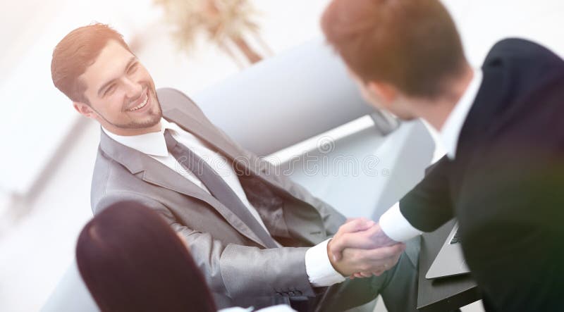 Handshake business partners in the lobby of the office. photo with copy space