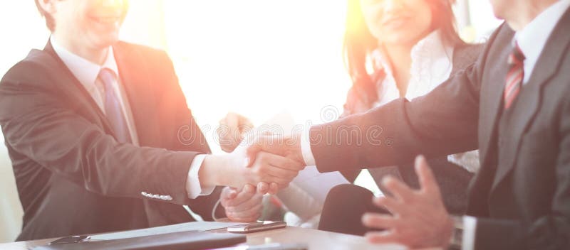 Handshake of Business Partners Sitting at a Desk Stock Photo Image of