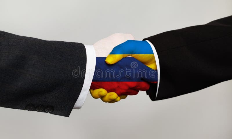 Handshake with flags of Ukraine and Russia. Peace talks and negotiations concept.