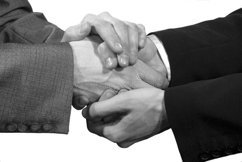 Handshake in four hands stock photo. Image of greeting 12676726