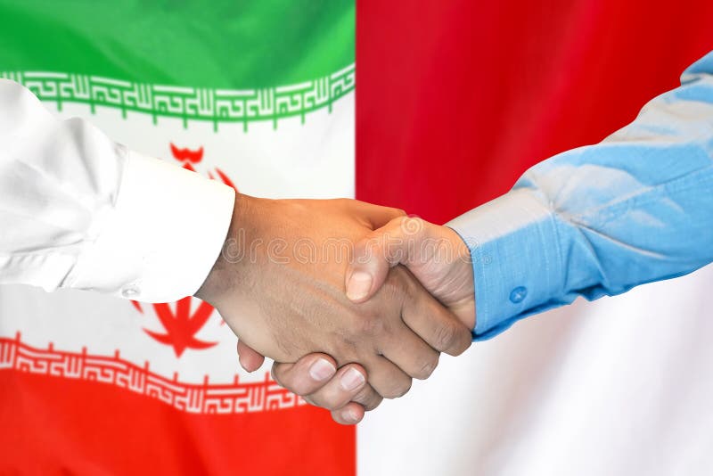 Handshake on Iran and Monaco flag background royalty free stock photos Handshake on Iran and Monaco flag background royalty free stock photos