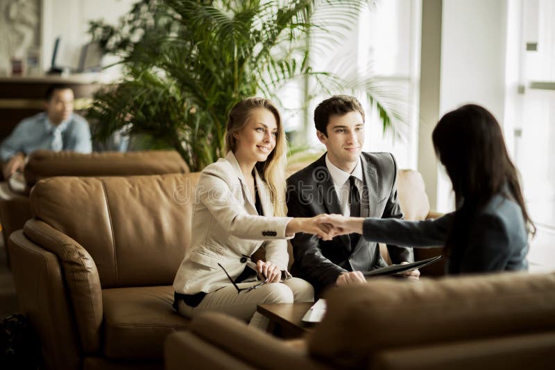 Handshake of the manager and the client after the contract discussion in the lobby of the modern office royalty free stock photo Handshake of the manager and the client after the contract discussion in the lobby of the modern office royalty free stock photo