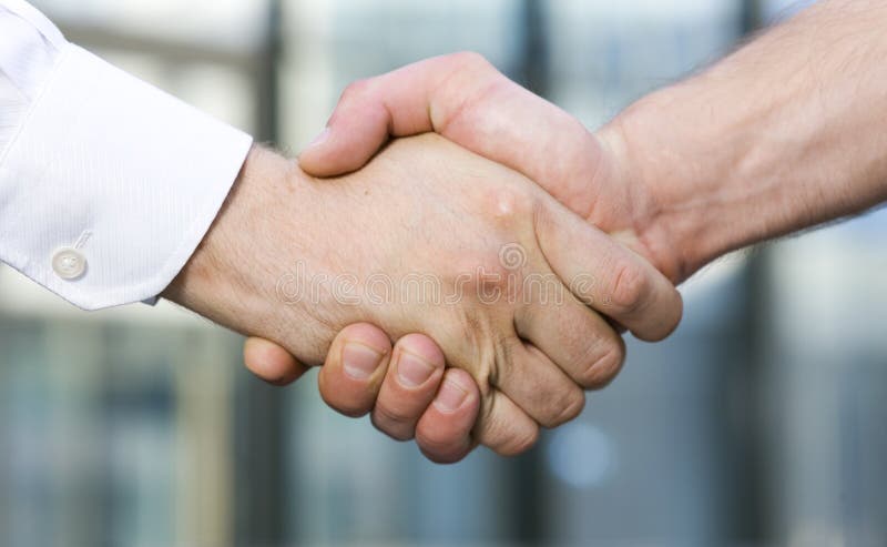 Handshake between office workers