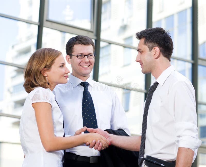 Handshake between office workers stock image