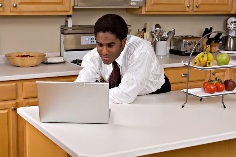 Handsome African-American businessman in kitchen royalty free stock photography