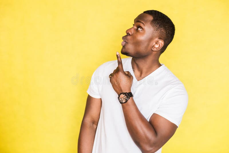 Handsome African American man indicates with forefinger at blank copy space. royalty free stock image Handsome African American man indicates with forefinger at blank copy space. royalty free stock image