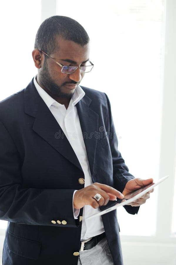 Handsome African man with tablet computer stock photo