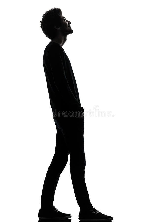 handsome african young man standing looking up smiling silhouette