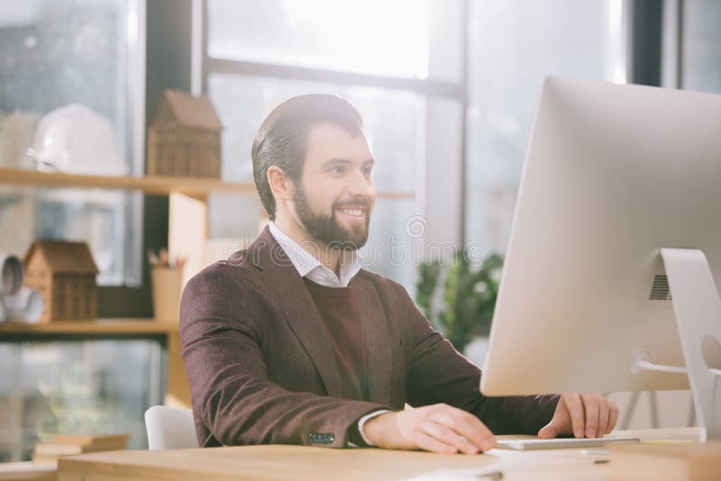 Handsome architect working with computer in office stock photos